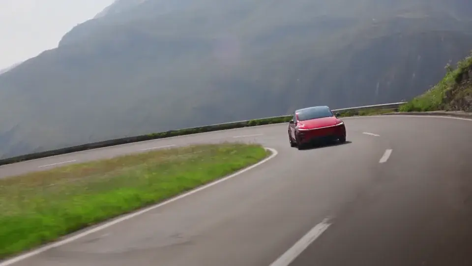 Red Tesla driving through a Utah canyon